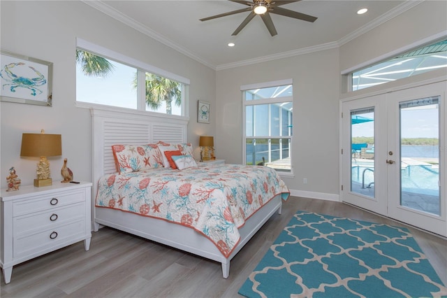 bedroom with access to outside, ornamental molding, wood finished floors, recessed lighting, and french doors