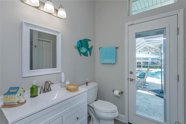 bathroom featuring toilet and vanity