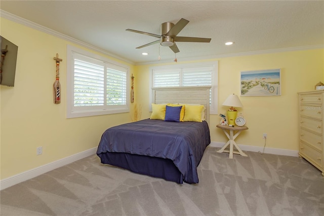 bedroom with a textured ceiling, light colored carpet, ceiling fan, and crown molding