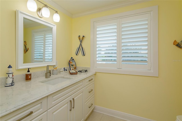bathroom with vanity, crown molding, tile patterned floors, and baseboards