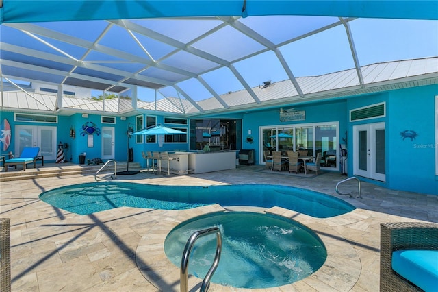 view of swimming pool with french doors, a patio, a pool with connected hot tub, and a lanai
