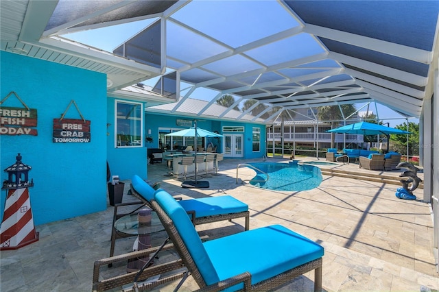view of pool featuring outdoor lounge area, french doors, a patio, glass enclosure, and a pool with connected hot tub