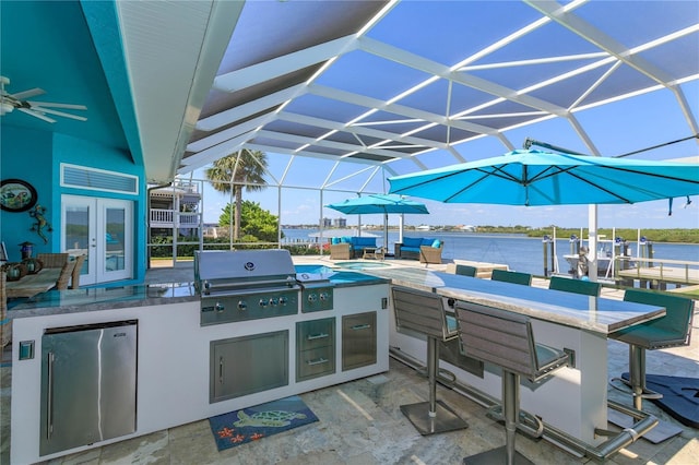 view of patio / terrace featuring area for grilling, exterior kitchen, a lanai, and french doors