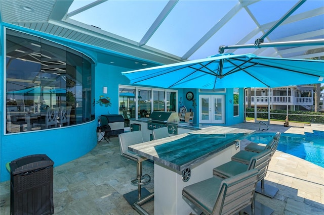 view of patio featuring glass enclosure, grilling area, french doors, an outdoor bar, and area for grilling