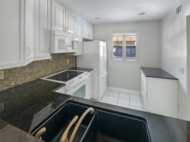 kitchen with backsplash, white appliances, sink, white cabinetry, and light tile patterned flooring