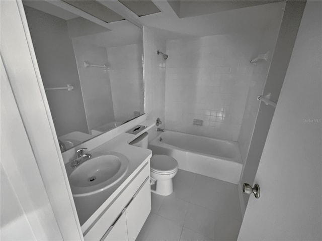 full bathroom with tile patterned flooring, toilet, vanity, and tiled shower / bath