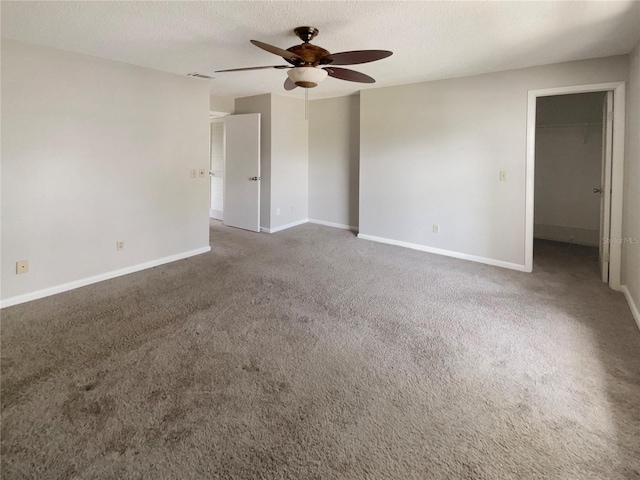 unfurnished room featuring carpet, a textured ceiling, and ceiling fan