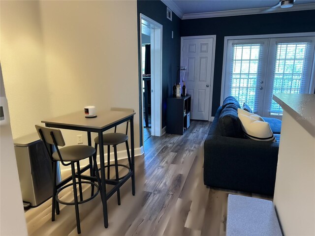 dining area featuring ornamental molding, french doors, and hardwood / wood-style flooring