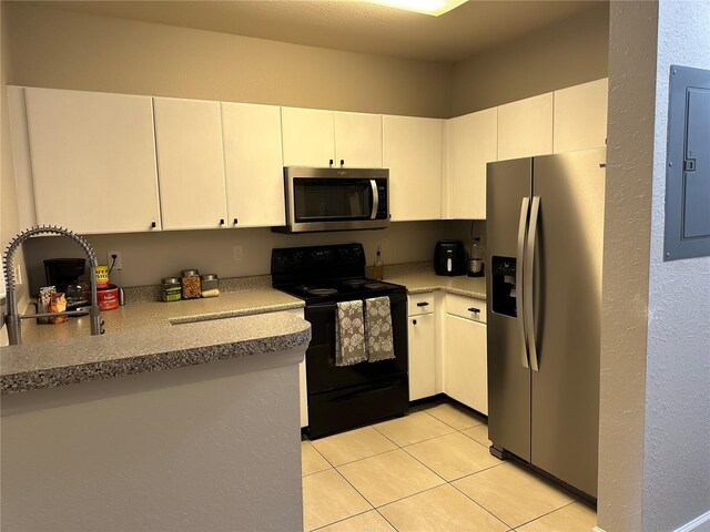 kitchen featuring stainless steel appliances, white cabinetry, and light tile flooring