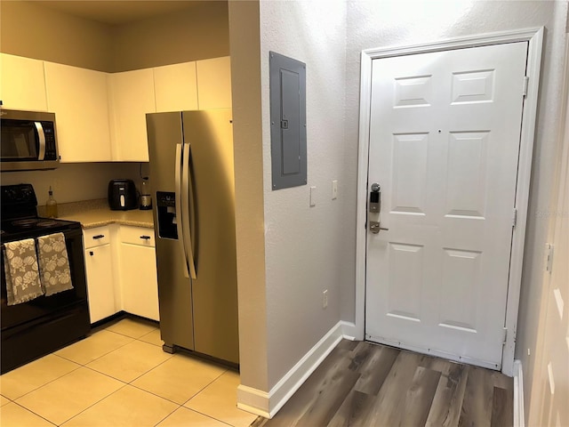 kitchen with appliances with stainless steel finishes and light hardwood / wood-style flooring