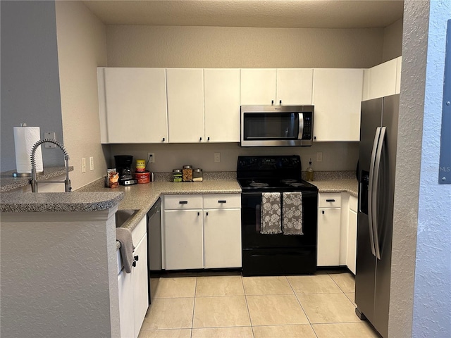 kitchen featuring appliances with stainless steel finishes, white cabinetry, and light tile floors