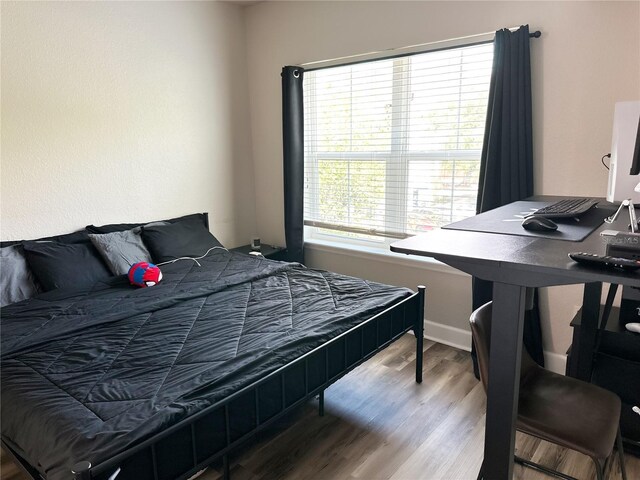 bedroom with hardwood / wood-style flooring