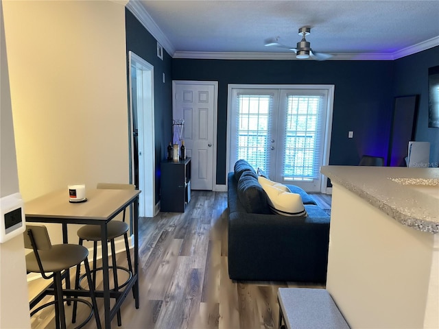 living room featuring french doors, ceiling fan, dark hardwood / wood-style floors, and crown molding