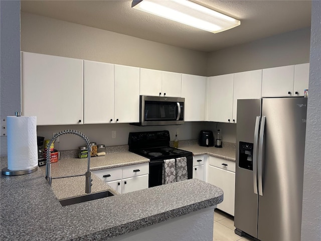 kitchen featuring kitchen peninsula, white cabinets, sink, light tile floors, and appliances with stainless steel finishes