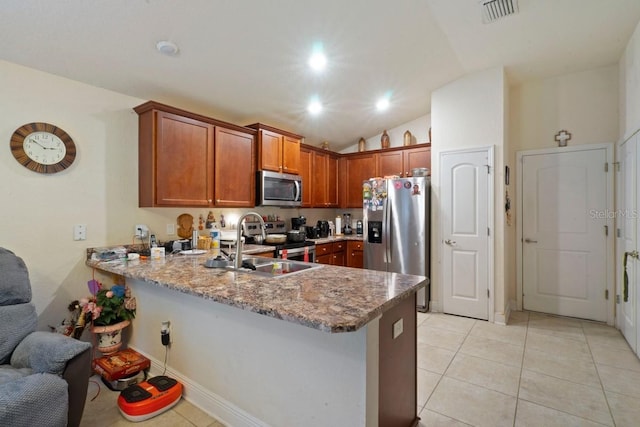 kitchen with kitchen peninsula, sink, light stone countertops, stainless steel appliances, and light tile patterned floors