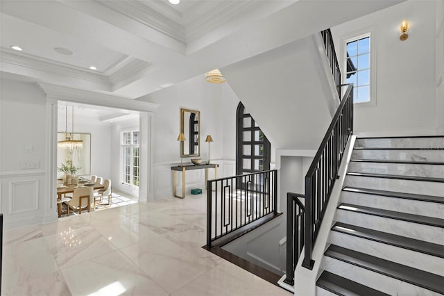 9832 Laurel Valley Dr, Windermere, FL 34786 - staircase featuring a decorative wall, a chandelier, marble tiled floors, wainscoting, and healthy amount of natural light