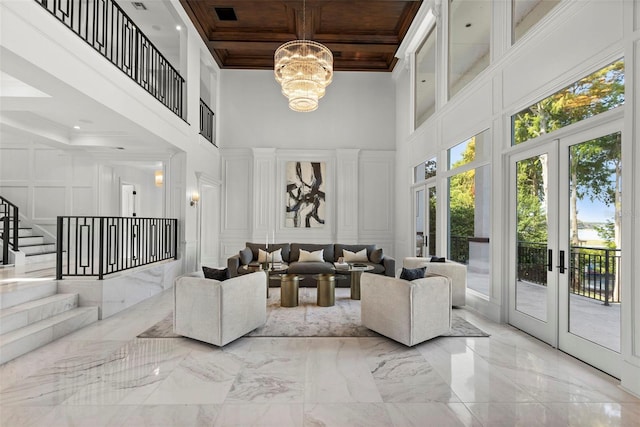 living room with french doors, wood ceiling, crown molding, a notable chandelier, and a high ceiling