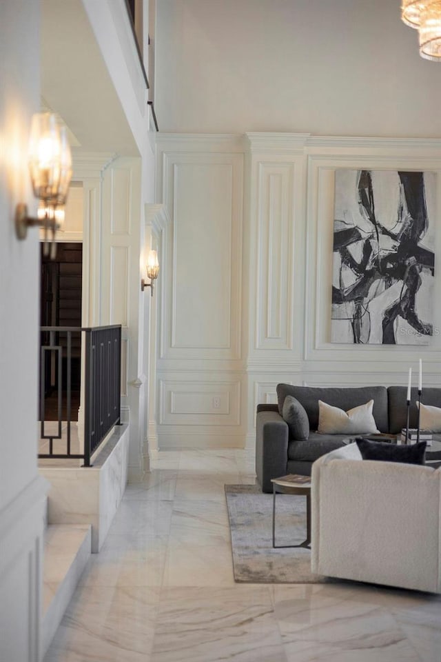 9832 Laurel Valley Dr, Windermere, FL 34786 - living area featuring a decorative wall, a chandelier, and light marble finish floors