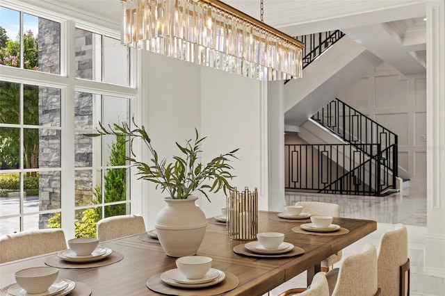 9832 Laurel Valley Dr, Windermere, FL 34786 - dining area with stairs, a high ceiling, and a decorative wall