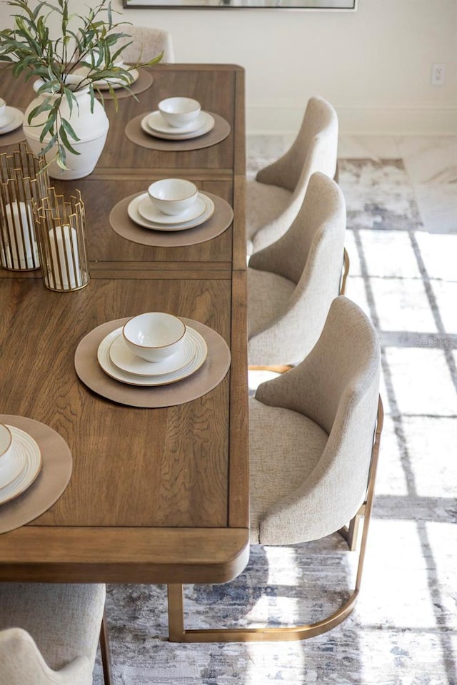 dining space featuring marble finish floor