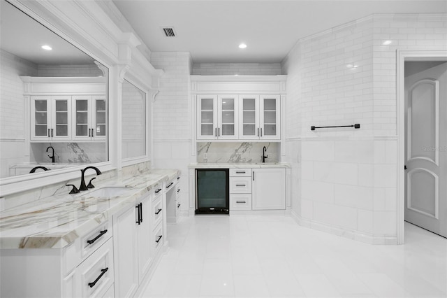 9832 Laurel Valley Dr, Windermere, FL 34786 - indoor wet bar with wine cooler, light tile patterned flooring, tile walls, and recessed lighting