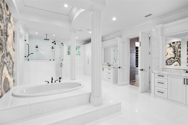 bathroom with ornate columns, ornamental molding, vanity, tile walls, and shower with separate bathtub