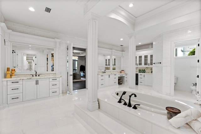 9832 Laurel Valley Dr, Windermere, FL 34786 - bathroom featuring decorative columns, crown molding, vanity, a bath, and a bidet
