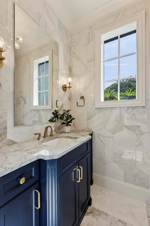 bathroom featuring vanity, crown molding, and tile walls