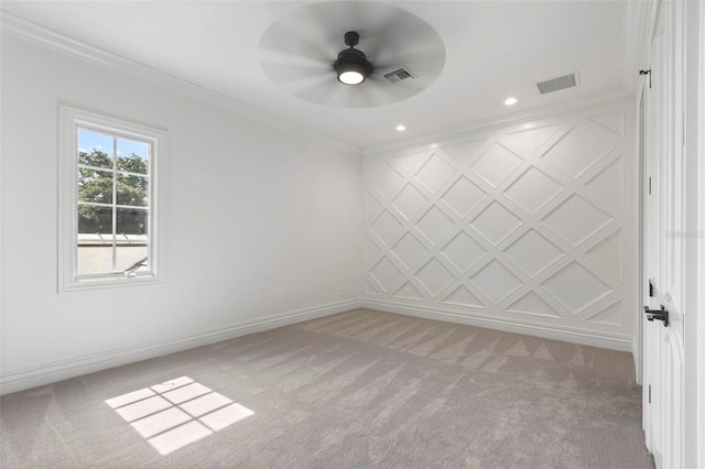 unfurnished room featuring visible vents, light colored carpet, crown molding, and baseboards