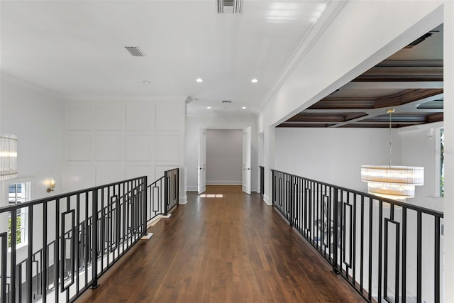 hallway with a chandelier, dark hardwood / wood-style flooring, and crown molding