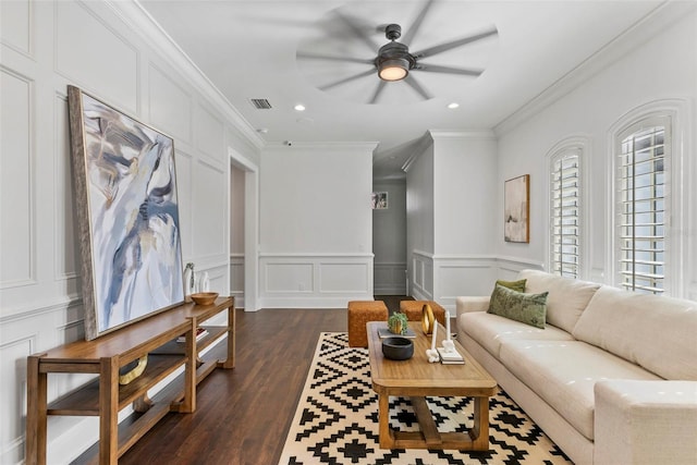 living room with ceiling fan, crown molding, and dark wood-type flooring