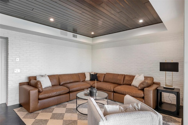 living area featuring recessed lighting, wood ceiling, and brick wall