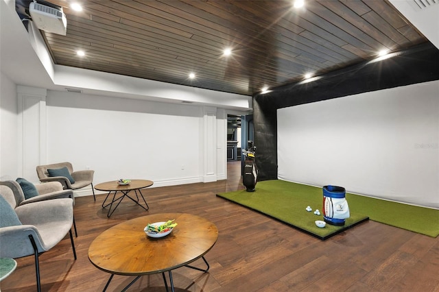 home theater room featuring dark hardwood / wood-style floors, golf simulator, and wooden ceiling