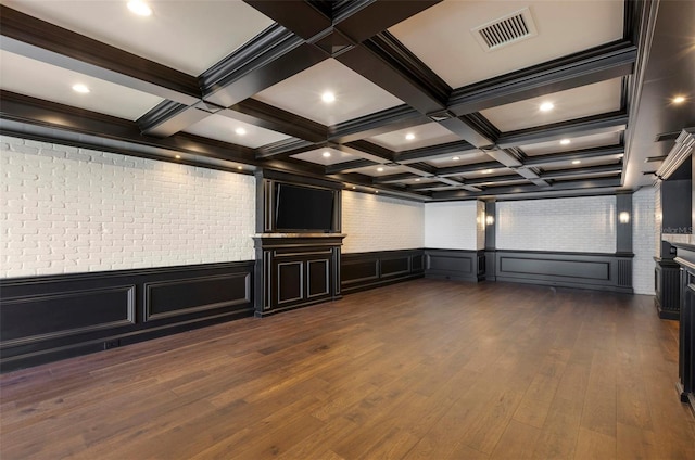 spare room with visible vents, beam ceiling, coffered ceiling, and dark wood-style floors