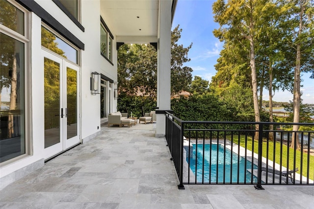 view of patio / terrace featuring french doors and a fenced in pool