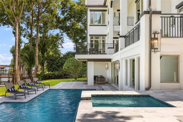 9832 Laurel Valley Dr, Windermere, FL 34786 - back of house with a balcony, stucco siding, a patio, and an outdoor pool