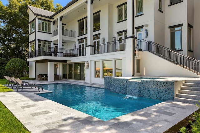 9832 Laurel Valley Dr, Windermere, FL 34786 - back of property with stucco siding, stairway, a patio area, and a pool with connected hot tub