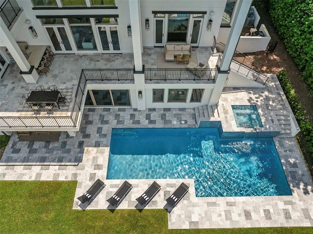 exterior space featuring an outdoor living space, a patio area, and french doors