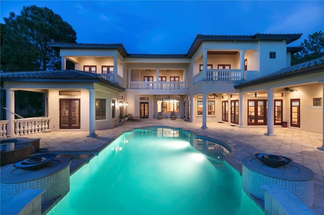 view of pool with french doors, an outdoor fire pit, a patio area, and ceiling fan