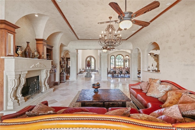 living room with a chandelier, decorative columns, crown molding, and a high end fireplace