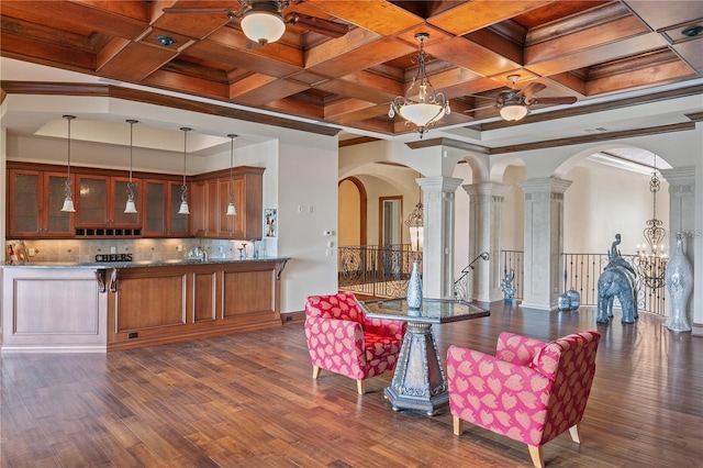 dining area featuring ornate columns, crown molding, dark hardwood / wood-style flooring, and coffered ceiling