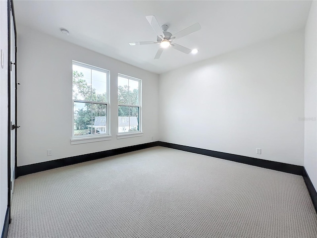 unfurnished room featuring light colored carpet and ceiling fan