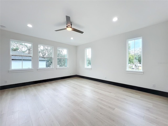 spare room featuring ceiling fan and light hardwood / wood-style flooring