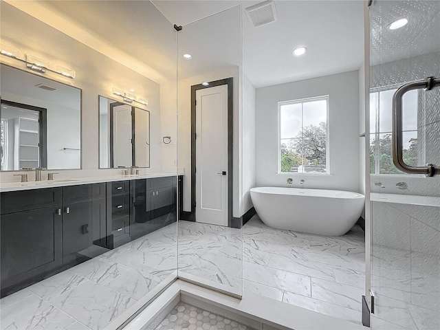 bathroom featuring vanity and a tub to relax in