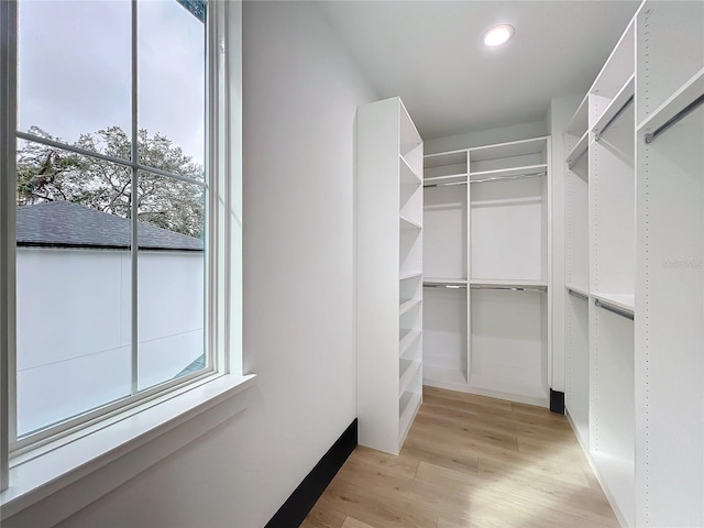 walk in closet featuring light hardwood / wood-style flooring