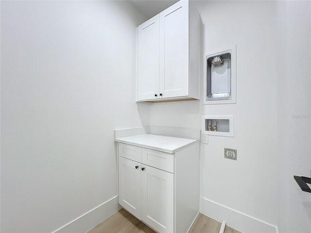 laundry room with washer hookup, electric dryer hookup, cabinets, and light wood-type flooring