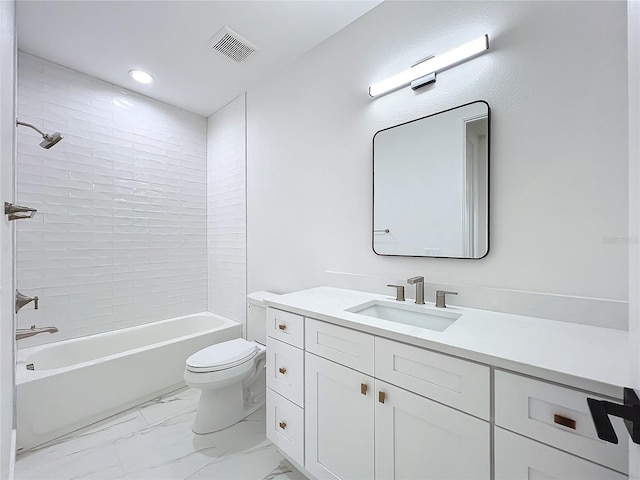 full bathroom with toilet, vanity, and tiled shower / bath