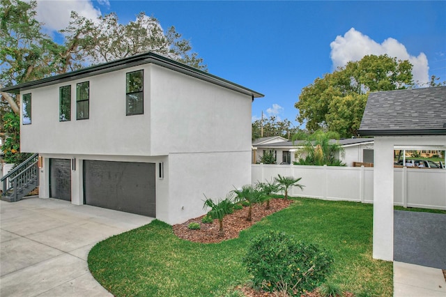 view of property exterior with a yard and a garage