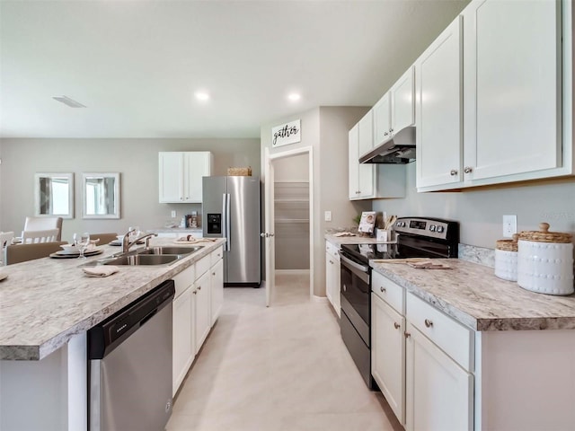 kitchen with sink, white cabinetry, stainless steel appliances, and a kitchen island with sink