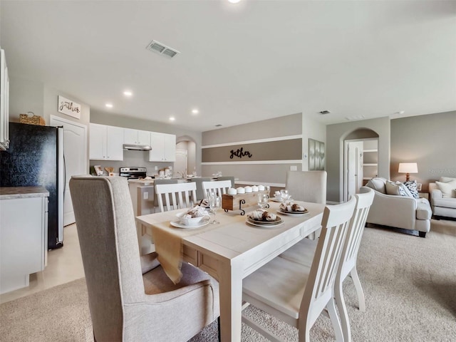 dining area featuring light colored carpet